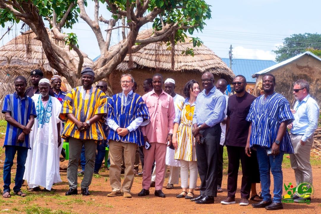 A large group gathered outdoors in a community setting.